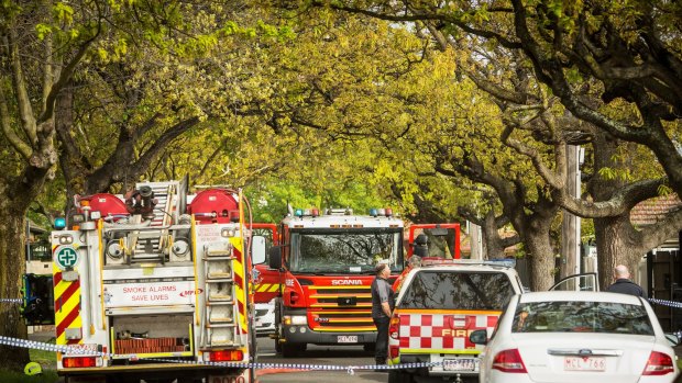 Fire crews outside 3 Berrima Avenue, Malvern East after the bungalow fire.