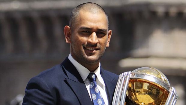 India captain Mahendra Singh Dhoni poses with the World Cup trophy.