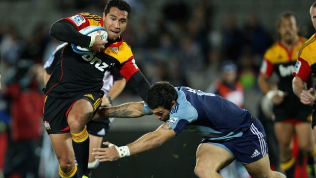 Mils Muliaina of the Chiefs is tackled by the Blues' Rene Ranger.