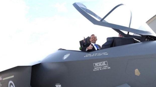 Prime Minister Tony Abbott in the cockpit of of a replica Joint Strike Fighter. The government will buy 58 jet fighters.