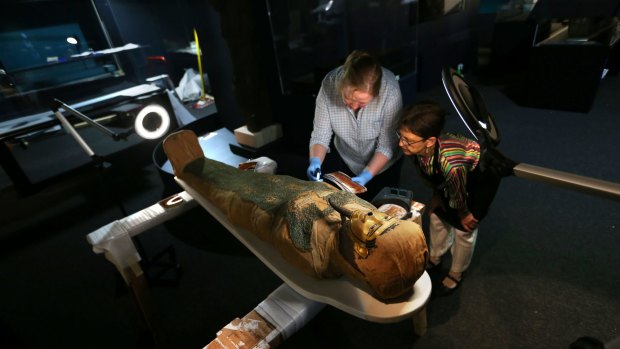 Senior conservator from the British Museum Nicky Newman (left) and Powerhouse Museum conservator Gosia Dudek inspect Irthorru, a mummy from the British Museum's collection on loan to the Powerhuse Museum's exhibition Egyptian Mummies: Exploring Ancient Lives. 