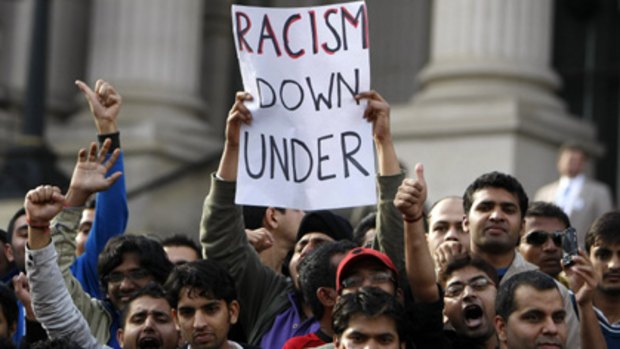 Indian students hold a placard at a protest in Melbourne while demanding that the Australian government and police do more to protect students from violence.