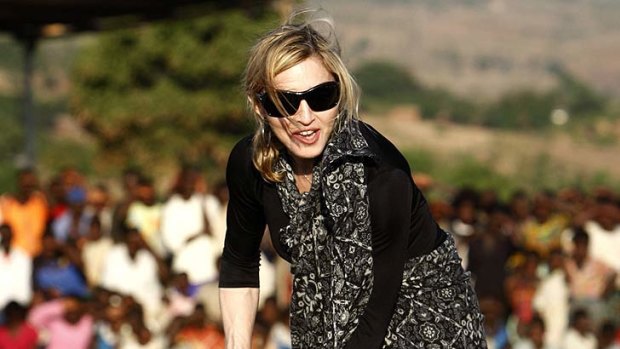 Sod it ... Madonna turns the soil at the site of the girls' school outside Lilongwe in 2009. The plan was later scrapped.