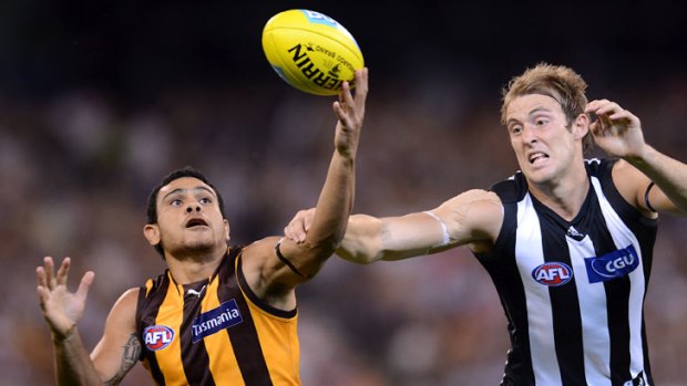 Hawthorn's Cyril Rioli gives Collingwood's Ben Reid the slip at the MCG.