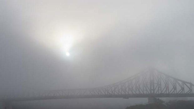 The sun struggles to shine through the fog covering Brisbane.