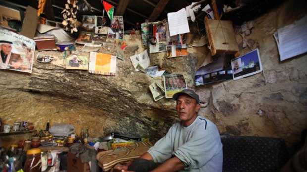 Abdel Fattah Abd Rabbo sits in his cave.