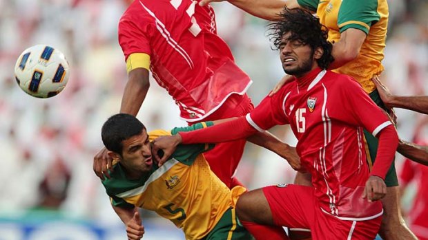 Down and out: Australia's Aziz Behich battles for the ball in the Olympic Games qualifier against the UAE.