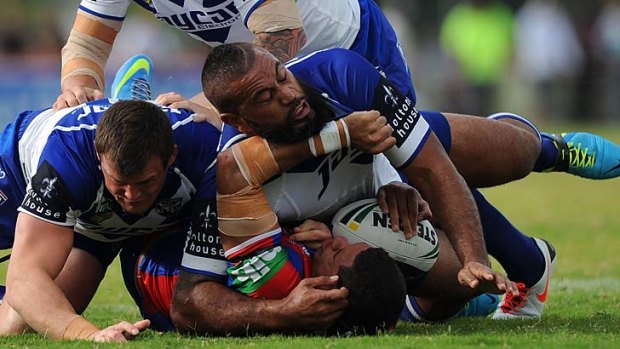 Dane Gagai of the Newcastle Knights is tackled during the match against the Canterbury Bulldogs.
