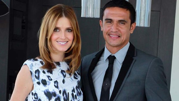 Dressed to impress: Kate Waterhouse with soccer player Tim Cahill, in a Shoreditch suit.