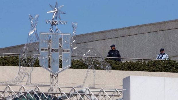 Australian Federal Police officers patrol Parliament House on Friday.