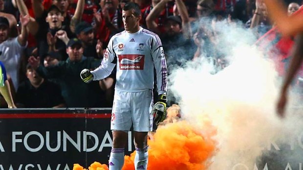 Sydney FC goalkeeper Ivan Necevski looks on as a flare is lit during the match against the Western Sydney Wanderers last Saturday.