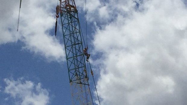 The man climbed the crane early on Sunday morning before ascending to arround halfway. 