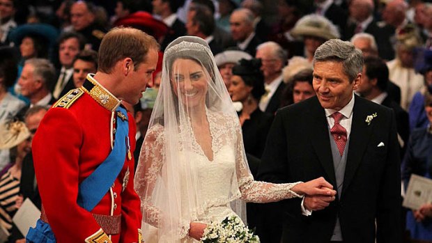 Relaxed ... Prince William stands at the altar with his bride, Kate Middleton, and her father Michael.