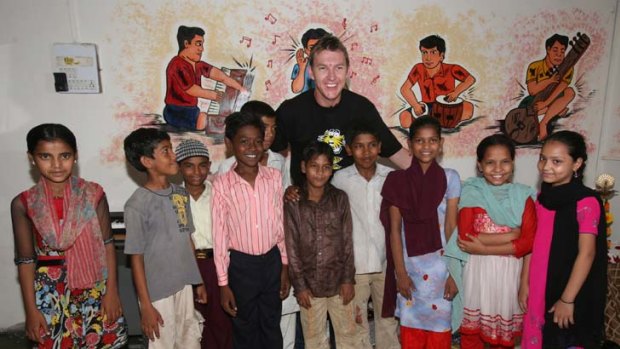 Musical mission ... Brett Lee with some of the children at the music studio he has opened in Mumbai, India. The children receive free music lessons.
