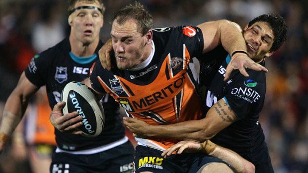 Hail to the chief ... Wests Tigers' Gareth Ellis shows no mercy as he bursts through a tackle from the Panthers.