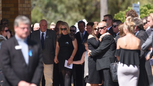 LOVING FAMILY: Jane and Ian Thomson support each other, with daughter Bessie and sons Colin and Braden behind, as more than 150 people gathered to pay their respects to their eldest child Riharna. 