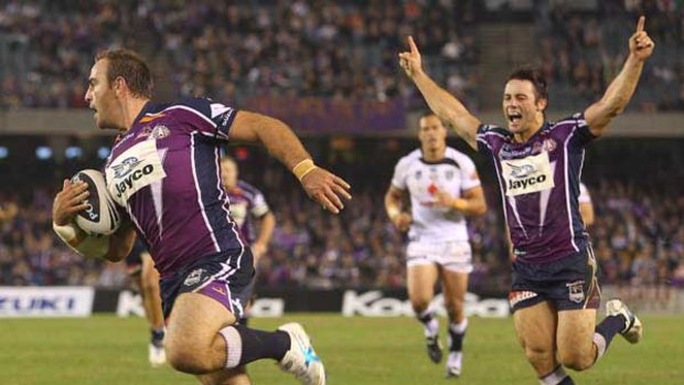 A try’s a try ... Cooper Cronk celebrates as Ryan Tandy scores for the Storm against the Warriors at Etihad Stadium  last night. Melbourne are determined to make the season count, points or no points.