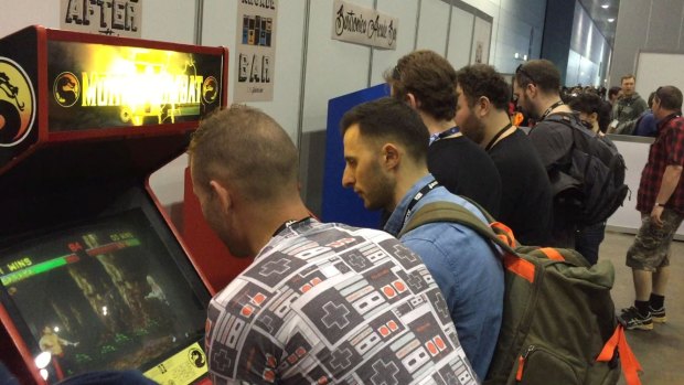 Friends challenging each other to Mortal Kombat at PAX Australia.