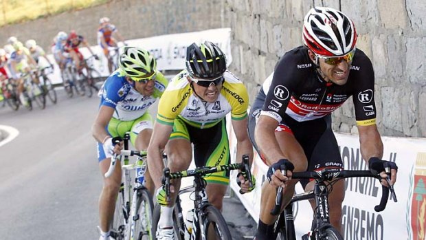 Fabian Cancellara  of Switzerland, Simon Gerrans of Australia and Vincenzo Nibali power up a climb in the final kilometres of Milan-San Remo.