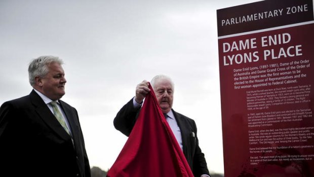 Peter Lyons and his son Peter Lyons unveil an interpretative panel honouring Dame Enid Lyons located near the National Library of Australia.