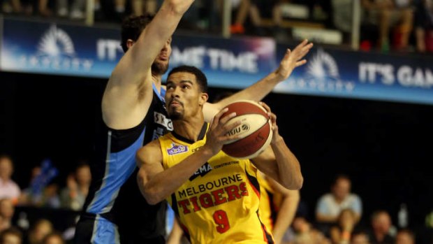 Melbourne Tigers import Mustapha Farrakhan looks to get past Breakers opponent Alex Pledger at North Shore Events Centre in Auckland.