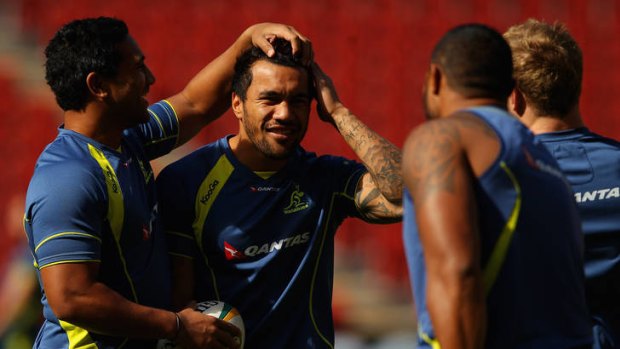 Head case: Cooper Vuna pats the head of Wallabies teammate Digby Ioane at the captain's run in Brisbane yesterday.