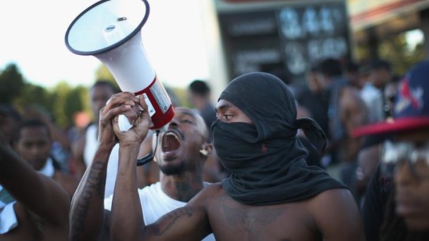 Demonstrators protest the killing by police of unarmed teenager Michael Brown.