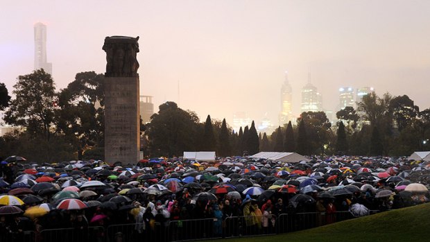 A sea of umbrellas as thousands pay their respects in the city.