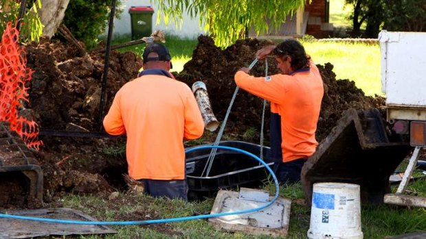 Contractors roll out the NBN in NSW. Work has halted in the Victorian town of Ballarat and is under threat in Tasmania due to contract disputes.