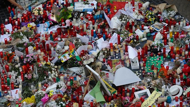 Flowers, messages and candles form a memorial tribute to the victims of terrorists.