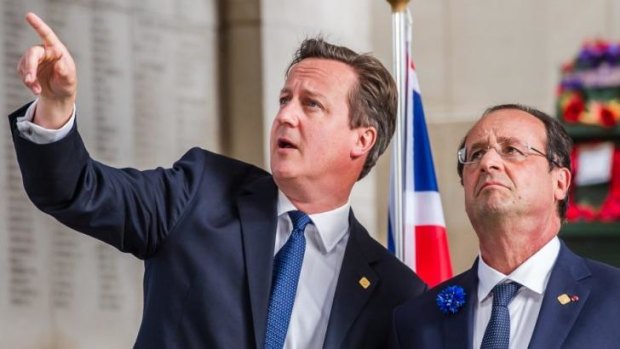 British Prime Minister David Cameron (left) speaks with French President Francois Hollande during a ceremony to mark the Centenary of World War I in Ypres, Belgium, on Thursday. 