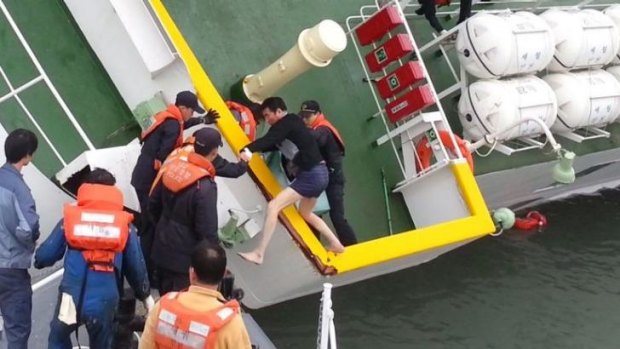Ferry captain Lee Joon-seok being rescued from the tilting vessel.