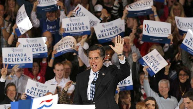 Another win ... Mitt Romney waves to his supporters while speaking at his Nevada caucus night rally.