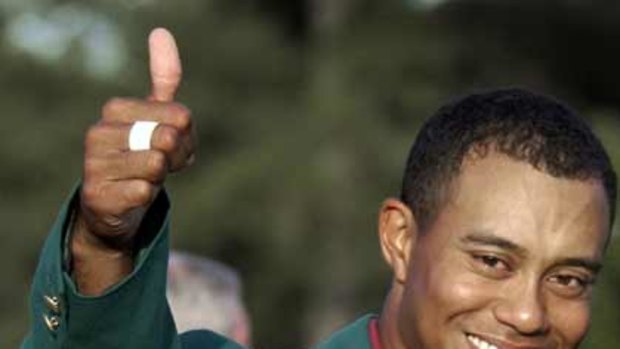 He's back ... in this April 14, 2002, file photo, Tiger Woods, wearing his green jacket, gives a thumbs up as he celebrates winning the Masters golf tournament at the Augusta National Golf Club in Augusta.