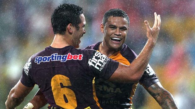 Josh Hoffman celebrates with Broncos teammate Corey Norman after scoring a try against the Titans.