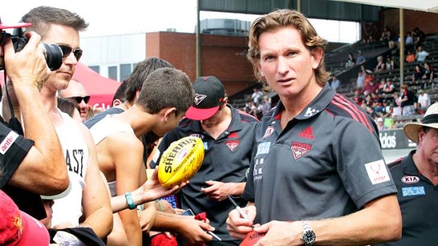 James Hird and Jobe Watson sign autographs at essendon's Family Day.