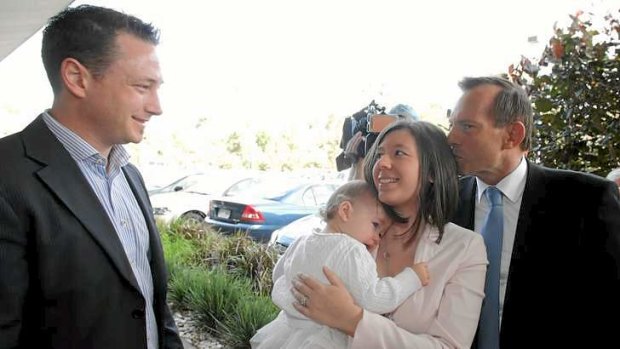 Awkward: Evie Whittaker gets a kiss from Tony Abbott.
