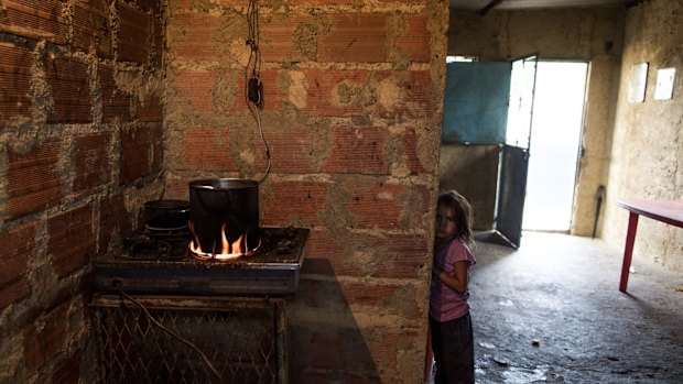 A child in her house in Barlovento waits for lunch, which consists of only boiled yam. Food sold in the black market can be 1000 per cent higher than what it cost in government-regulated grocery stores. 