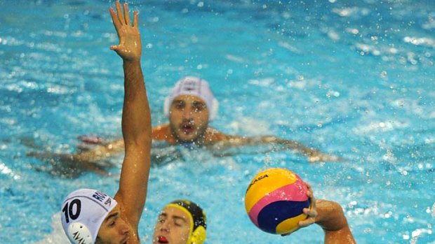 Shark bite: Richard Campbell, right, takes on Ramiro Georgescu as Australia beats Romania 9-8 in water polo at the world titles.