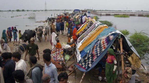 Displaced ... villagers take refuge on higher land in Badin district.
