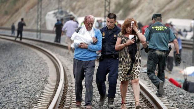 Victims are helped by rescue workers after the deadly train crash.