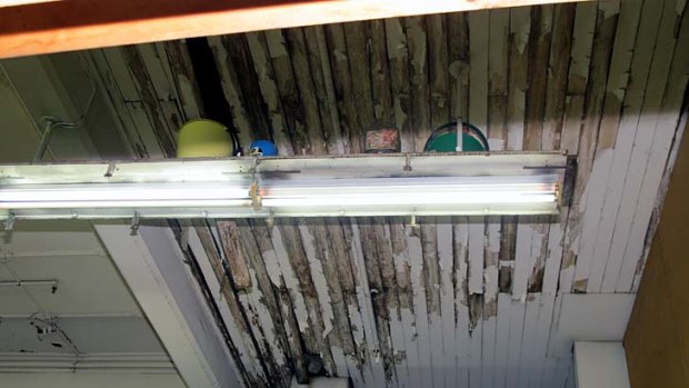 A damaged floor and ceiling in the Waltons building.