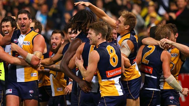 Nic Naitanui is mobbed by his teammates after he kicked the winning goal against North Melbourne.