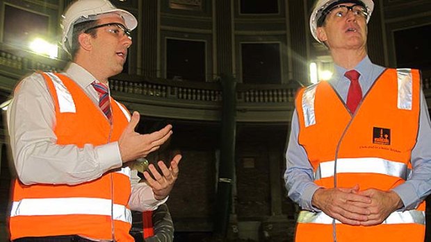 Councillor Matt Bourke (left) and Lord Mayor Graham Quirk inspect work progress in Brisbane City Hall's auditorium.