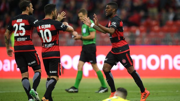 Stalemate: Roly Bonevacia, right, celebrates with teammates after scoring for the Wanderers in their draw against the Mariners.