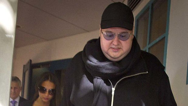 Kim Dotcom leaves the Auckland High Court yesterday afternoon flanked by his legal team and pregnant wife Mona.