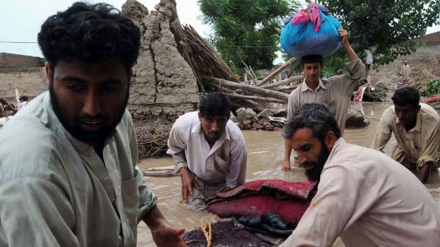 Local residents remove their belongings as they evacuate a flood-hit area of Nowshera. <i>Picture: AFP/A Majeed</i>