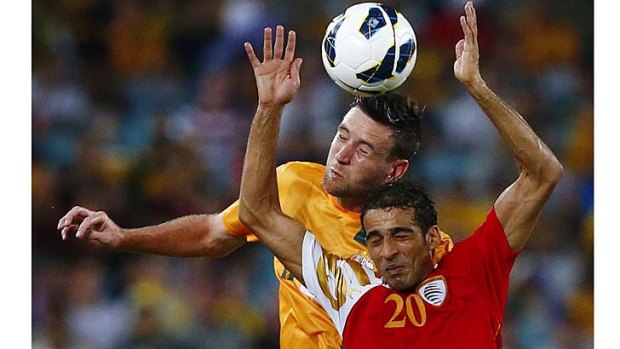 Robert Cornthwaite and Oman's Amad Al Hosni struggle for the ball during the World Cup qualifying match in Sydney in March.