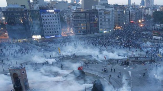 Protesters run as riot police fire teargas during a protest at Taksim Square in Istanbul. Turkish riot police fired volleys of teargas canisters into Istanbul's Taksim Square, centre of protests against Prime Minister Tayyip Erdogan, driving thousands into narrow side streets, witnesses said.
