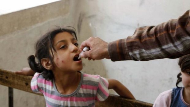 Health dose: A child receives a polio vaccination in Aleppo, Syria, in May.
